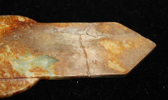 A Chinese yellow and russet jade tablet (gui), Ming dynasty or later, 19.1cm, broken and restored at pointed end, wood stand.